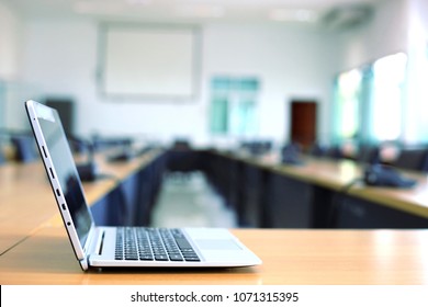 A Close-up Of A Laptop Computer Sitting On A Table In A Meeting Room Selective Focus And Shallow Depth Of Field