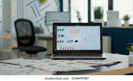 Closeup of laptop screen with enterprise resource planning showing moving charts and growing turnover in empty startup office. Interior of sales department with portable computer with erp software. - Shutterstock ID 2198499987