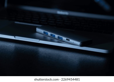 Close-up laptop, type-c hub with cable and usb receiver. Black background. place for inscription for designer
