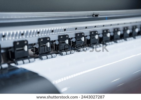 Close-up of large format printer heads in action, Detailed view of modern large format printer heads working on white media