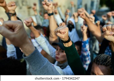 Close-up of large group of people with raised fists on public demonstrations.  - Shutterstock ID 1794342247