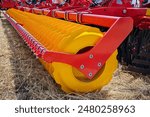 Close-up of a large modern plow yellow color or disc harrow for cultivating the land. New model of agricultural equipment. Selective focus.