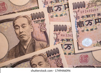 A Closeup Of A Large Pile Of 10, 000 Yen Japanese Bills.