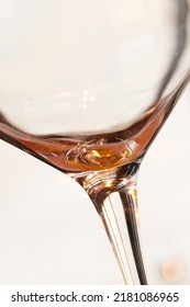 Closeup Of The Last Sip Of White Wine Against A Light Background With Copyspace. Zoom In On An Alcohol Beverage Being Enjoyed In Celebration. Macro View Of Style, Shape And Design Of A Wine Glass