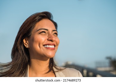 Close-up Of A Latina Woman Smiling Sideways. Copy Space