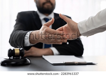 Closeup lawyer or attorneys colleagues handshake after successful legal discussing on contract agreement for lawsuit to advocate resolves dispute in court ensuring trustworthy partner. Equilibrium