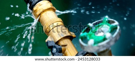 Closeup of leaky faucet spraying water leak drops drips