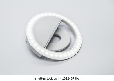 Close-up LED Selfie Circular Ring Light Lamp On White Background. Clip-on Flash Light Camera Phone For Taking Selfie Photos And Videos. Compact And Lightweight Device For Bloggers And Vloggers.