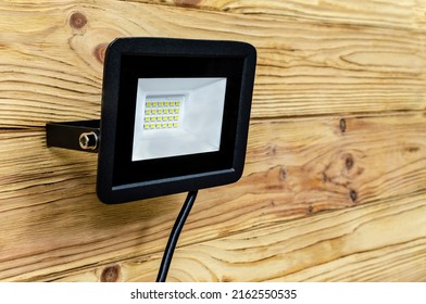 Close-up of an LED spotlight on a wooden building.