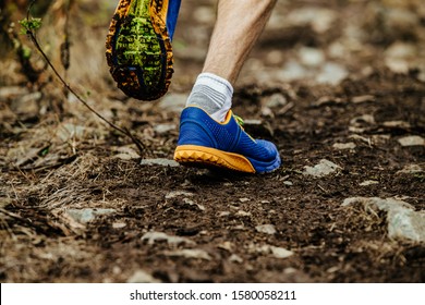 Closeup Legs Running Shoes Athlete Run Uphill On Muddy Trail