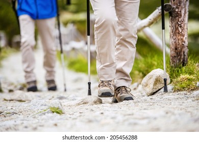 Close-up of legs of senior couple hiking at the beautiful mountains