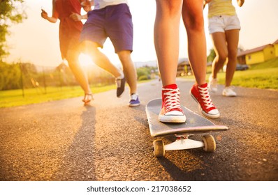 Closeup of legs and sneakers of young people on skateboard - Powered by Shutterstock