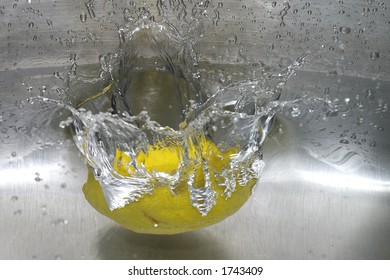 Closeup Of A Lemon Spashing Into A Pool Of Water