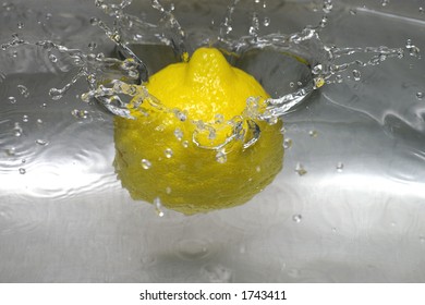 Closeup Of A Lemon Spashing Into A Pool Of Water