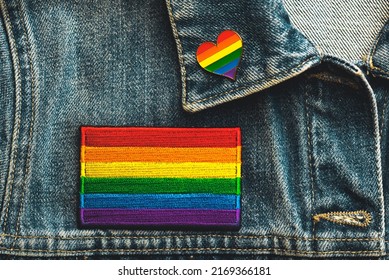 Close-up Of LGTBI Flag Textile Patch On A Denim Jacket And LGTBI Pin Heart Shaped. Pride Day Concept.Selective Focus