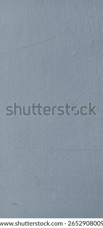 Close-up of a light blue painted wall with visible texture, fine scratches, and subtle marks, creating a worn and weathered surface ideal for background or design use.

