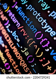Closeup of lines of computer code displayed on a digital screen with colorful letters and numbers in dark mode on a black background