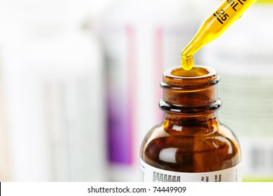 Closeup Of Liquid Medicine In Glass Dropper And Bottle