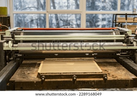 Close-up of a lithographic press or rolling press used for creating lithography, or a machine for drawing pictures using a stone.