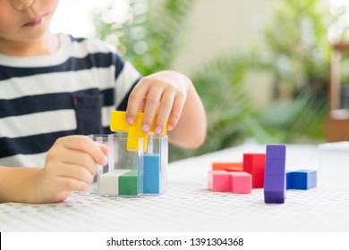 Closeup Of A Little Boy's Hands Playing Colorful Block Puzzles, Problem Solving, Cognitive Skill, Concentration/emotional Intelligence, Learn Through Play, Early Education, Child Development Concept.