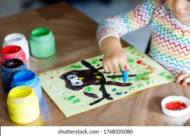 Closeup Of Little Creative Toddler Girl Painting With Finger Colors An Owl Bird. Child Having Fun With Drawing At Home, In Kindergarten Or Preschool Daycare. Games, Education And Distance Learning For