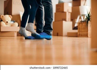 Close-up Of Little Girl Standing On Father's Feet And Dancing After Moving Into Hew Home. Copy Space. 