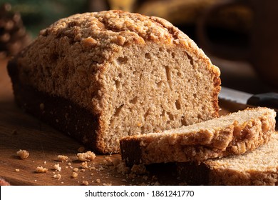 Closeup Of A Loaf Of Banana Nut Bread Sliced On A Rustic Cutting Board