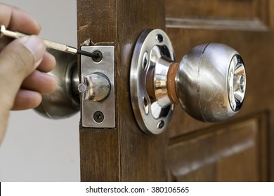 Closeup Of Locksmith On Old Wood Door , Repair