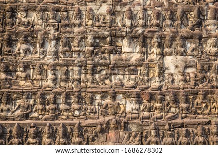 A closeup of long rows of mythical creatures called 'apsara,' Khmer angels, carved in the famous Elephant Terrace, a UNESCO World Heritage Site in Siem Reap, Cambodia.