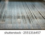 Close-up of a loom weaving colorful fabric