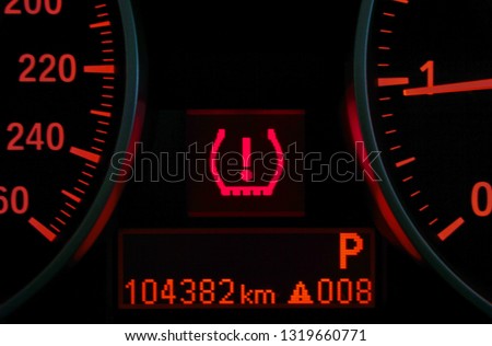 Closeup of lose tire pressure alert in dashboard car on background.                              