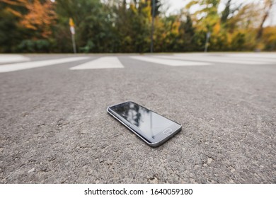 Close-up Of Lost New Phone On The Road