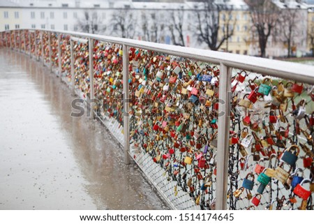 Closeup of love lockers at famous bridge Makartsteg in Salzburg, Austria. Padlocks of love on a bridge, the Makartsteg