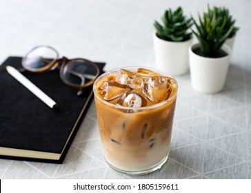 Close-up A Lovely Cup Of Ice Coffee Latte At Home In A Restaurant Stye In Coffee Break Hour With Black Notebook Pencil And Glasses, Coffee Break Concept