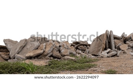 Close-up low angle view isolate of concrete debris, removed from road demolition and dumped on the ground, commonly seen in rural Thai road construction.