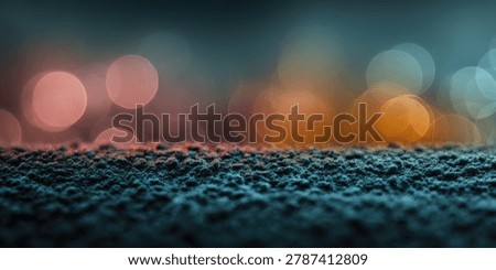 A close-up, low-angle view of a textured surface with blurred, colorful bokeh lights in the background, creating a dreamy atmosphere.