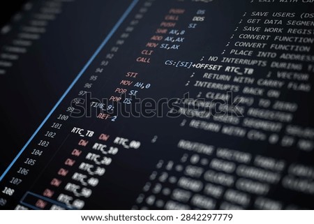 Close-up of low-level programming code displayed on a dark compu