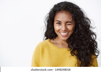 Close-up lucky successful young female college student, african american girl in yellow sweater winking and smiling encouraged, feeling good fortune on its way, stand positive white background - Shutterstock ID 1498298018