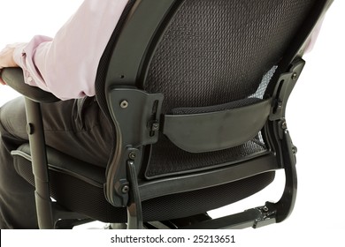 Closeup Of The Lumbar Region Of A Man Sitting In An Ergonomic Office Chair.  Isolated On White.