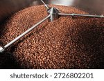 Close-up of a machine cooling  drum full of coffee beans, showing the process of an industrial production
