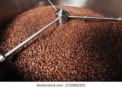 Close-up of a machine cooling  drum full of coffee beans, showing the process of an industrial production