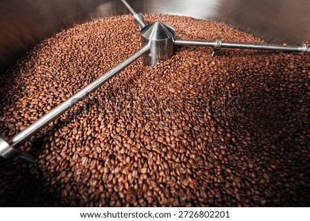Close-up of a machine cooling  drum full of coffee beans, showing the process of an industrial production