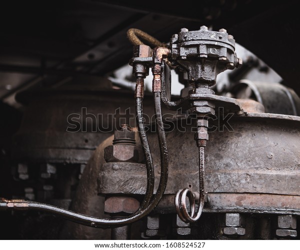 A closeup of a machine of a railroad\
wagon under sunlight with a blurry\
background