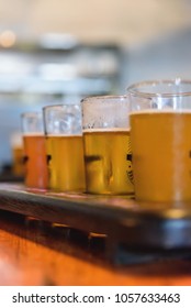 Closeup Macro Of Beer Flight On Wooden Paddle At Table