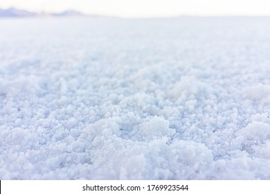 Closeup Macro Low Angle Ground Level View Of Texture Of Bonneville Salt Flats With Wet Salt On Ground Abstract With Horizon In Background