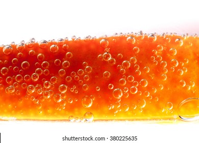 Closeup Macro Of Orange Slice In Bubbling Seltzer Water