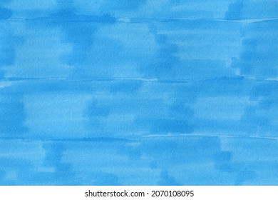closeup macro of permanent blue marker doodles brushes on white background paper with visible surface fiber structure details 