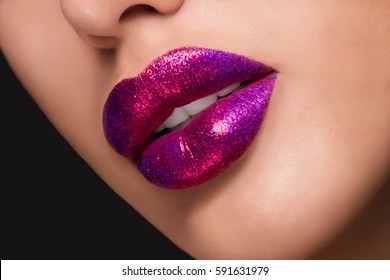 Close-up macro photo of a bright pink sequin sexy lips with white teeth