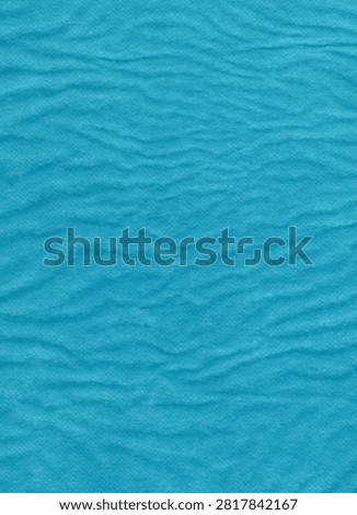 Close-up macro shot of a bright blue textured paper surface featuring a repeating wavy, rippled pattern, creating a soft and organic aesthetic.