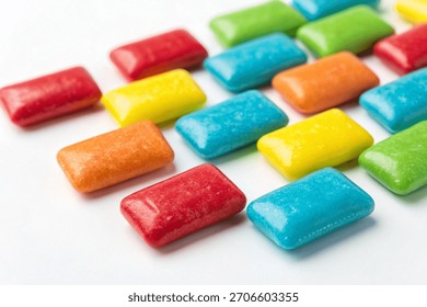 A close-up macro shot of colorful rectangular chewing candies isolated on a white background. Perfect for commercial packaging.
